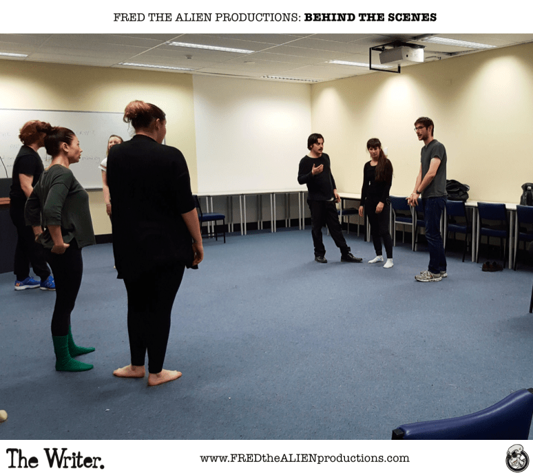 Director Michael Davidson (extreme right) has a group discussion with some of the cast.